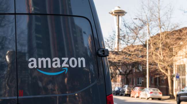 An Amazon Prime delivery van sits parked on a street in Seattle.