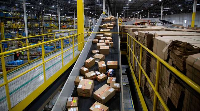 Packages move along a conveyor at an Amazon fulfillment center