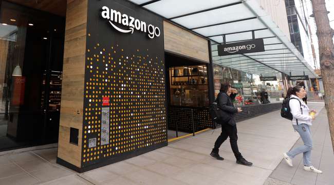 Customers exit an Amazon Go store in Seattle
