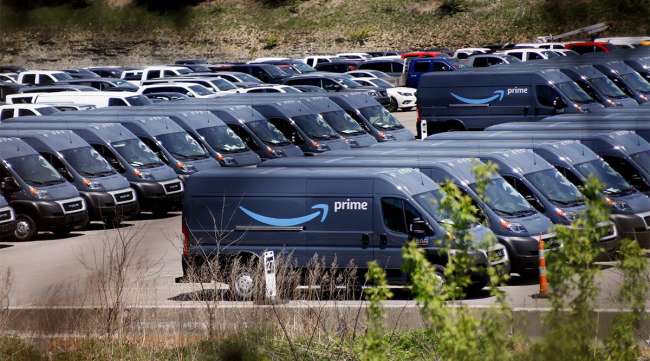 Rows of Amazon Prime delivery vans on a parking lot