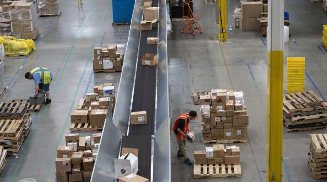 Employees work inside an Amazon fulfillment center in Baltimore in April 2019.