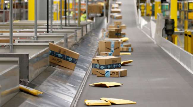 Packages move along a conveyor at an Amazon warehouse facility in Goodyear, Ariz.