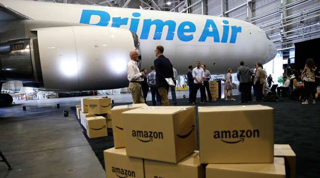 Amazon boxes stacked near a an Amazon "Prime Air" cargo plane in Seattle
