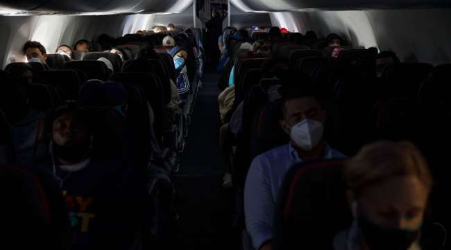 Passengers sit on an American Airlines flight departing from Los Angeles International Airport on June 13.