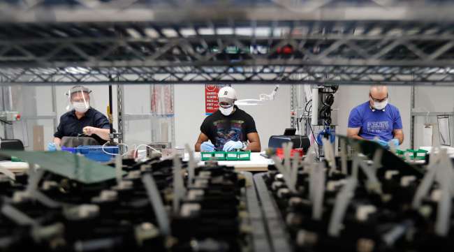 Ford line workers put together ventilators that the automaker is assembling at the Ford Rawsonville plant in Michigan on May 13.