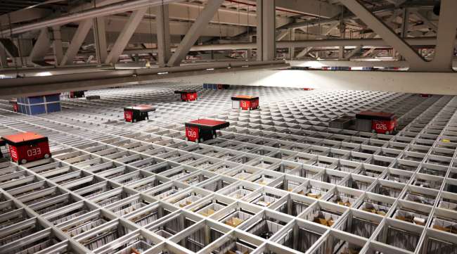 Automated warehouse robots, manufactured by AutoStore, deliver customer orders in Germany.