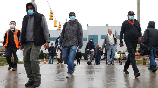 UAW members leave the Fiat Chrysler Automobiles Warren Truck Plant after the first work shift on May 18.