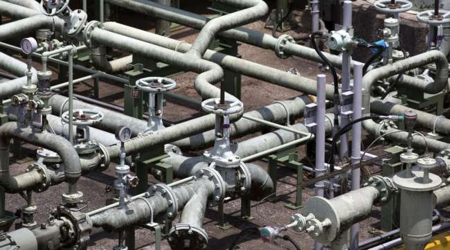 Pipes are seen near an LNG tank in Japan. (Bloomberg News)