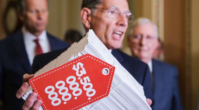 Sen. John Barrasso hoists a copy of the Democrats' $3.5 trillion "Build Back Better" package