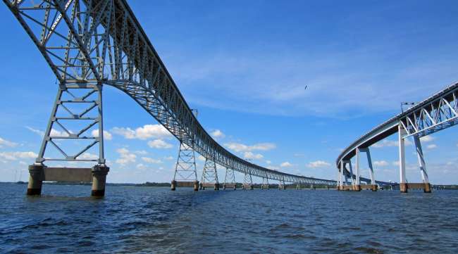 A view of the Chesapeake Bay Bridge from a boat on the water.