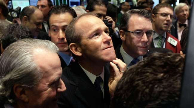 In this January 2011 file photo, Nielsen Company CEO David Calhoun, center, watches progress as he waits for the company's IPO to begin trading, on the floor of the New York Stock Exchange. Calhoun is Boeing's new CEO.