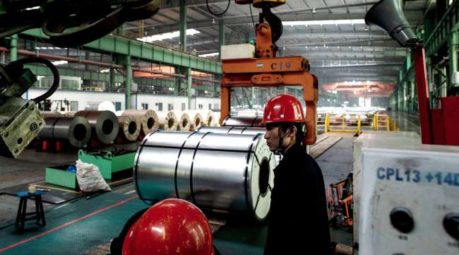 Chinese workers pack steel rolls in a Tangshan steel factory in 2016.
