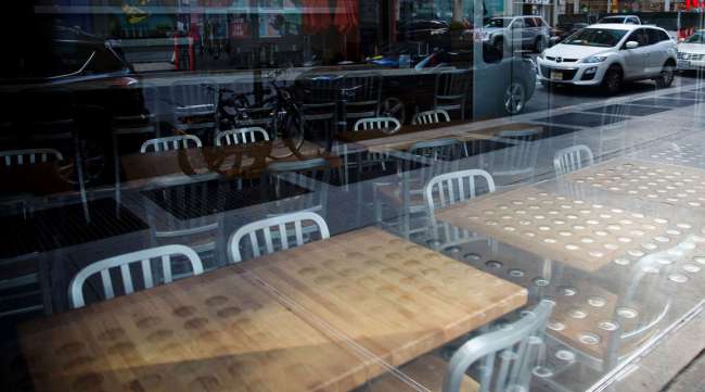 Chairs and tables sit inside a closed restaurant in Times Square in New York on April 21.