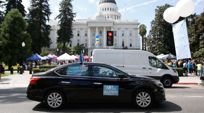 California is suing Uber and Lyft, alleging they misclassified their drivers as independent contractors under the state's new labor law.