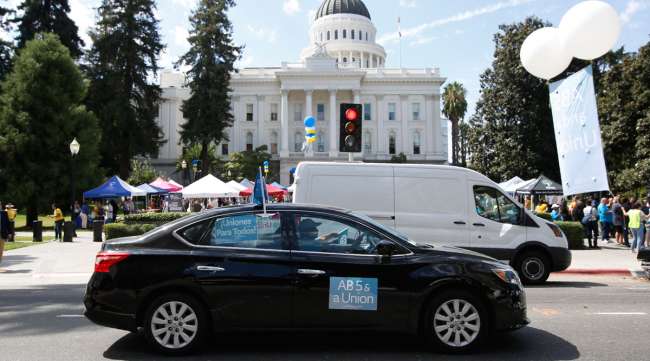 Dozens of AB 5 supporters rally at California's Capitol in Sacramento in August 2019. (Rich Pedroncelli/Associated Press)