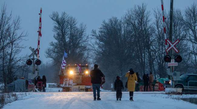 Demonstrators stand at a rail blockade during a protest in Ontario on Feb. 13.
