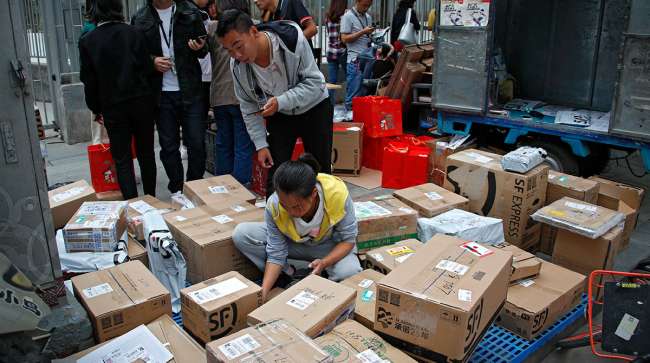 Delivery workers sort boxes in Beijing