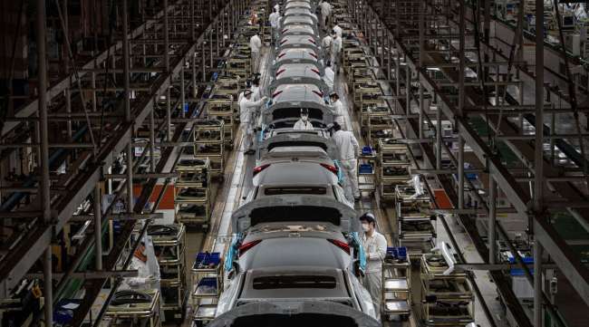 Employees work on an assembly line at a Dongfeng Honda plant in Wuhan, China,  on March 23.