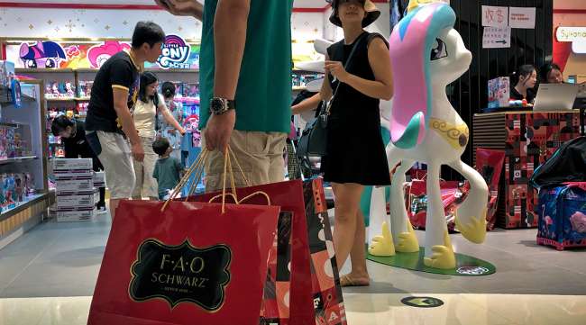 People shop at an FAO Schwarz toy store in Beijing.