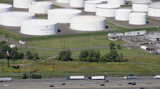I-95 traffic passes oil storage tanks owned by the Colonial Pipeline Company in Linden, N.J.