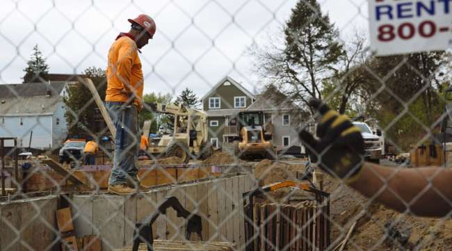 A worker stands at a housing construction site in New York on May 15.