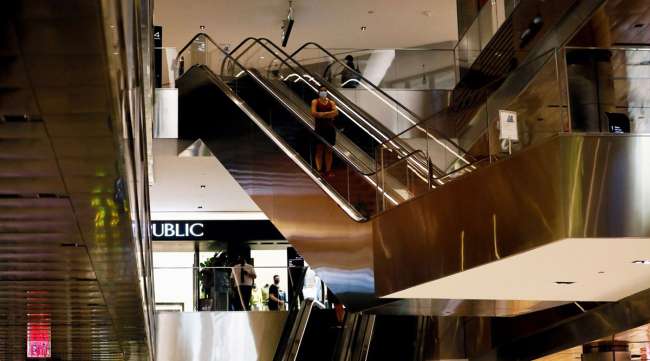 A shopper rides an escalator at the Hudson Yards mall in New York.