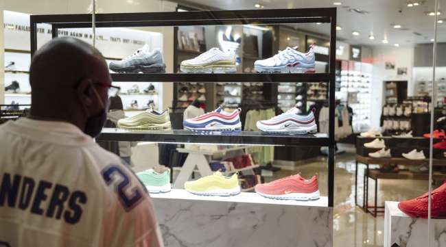 A shopper browses sneakers displayed in the window of a store in San Francisco.