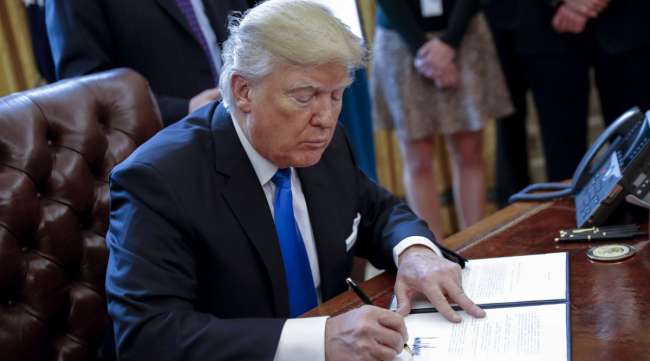 President Trump signs one of five executive orders related to the oil pipeline industry on Jan. 24, 2017. A federal judge on July 6 ruled that the Dakota Access Pipeline needed to cease operations in 30 days.