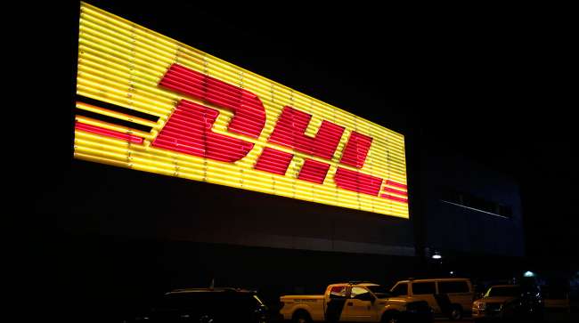 Neon DHL sign at night