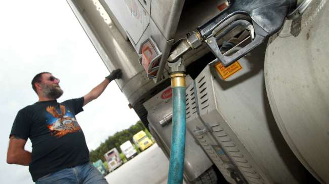 A driver fills his rig with diesel