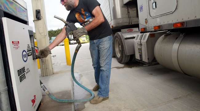 Driver filling up truck with diesel fuel