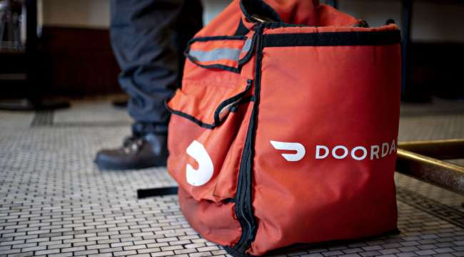 A DoorDash delivery bag sits on the floor inside a Washington, D.C., restaurant on March 26.
