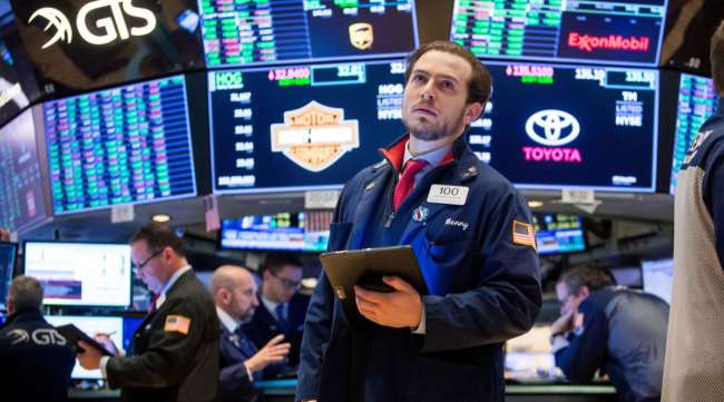 A trader reacts on the floor of the New York Stock Exchange on Feb. 26. For the last month, global stocks have cratered.