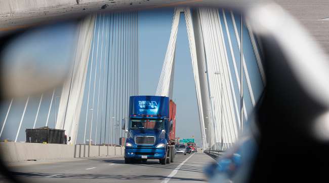 A truck as seen in a side-view mirror on the Mississippi River Bridge on I-70 in St. Louis, Missouri.