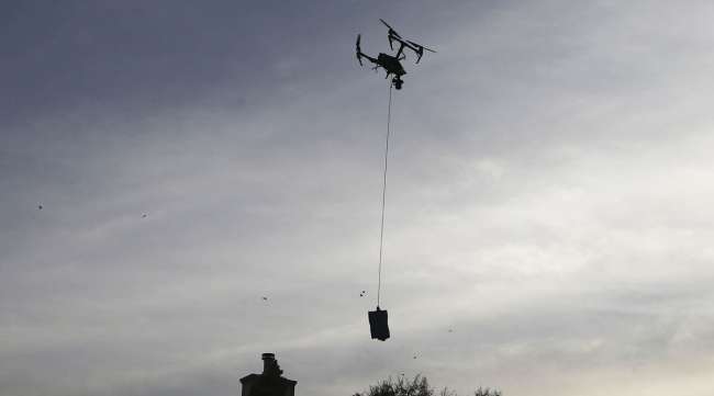 A drone descends to deliver a COVID-19 test kit to a home in El Paso, Texas. (Mario Tama/Getty Images via Bloomberg News)
