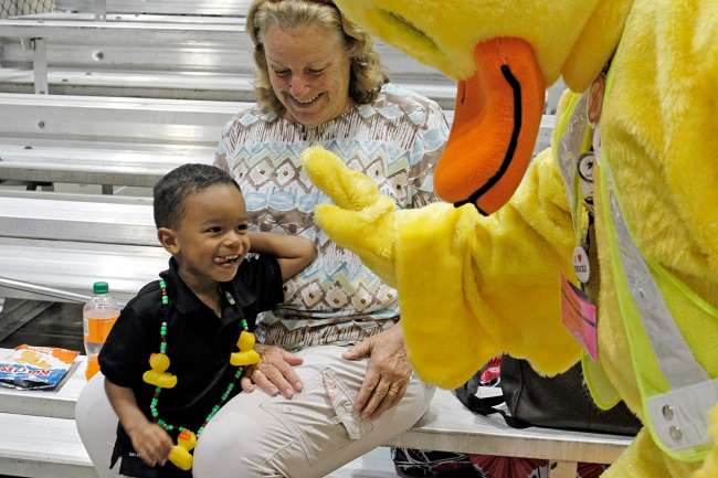 The duck mascot high-fives a young fan
