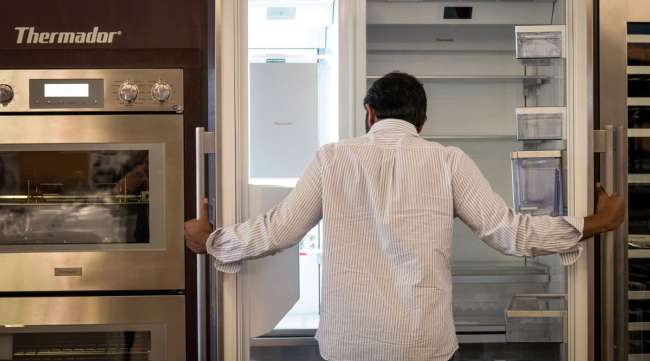A customer views a refrigerator displayed for sale at an appliance story in San Jose, Calif.