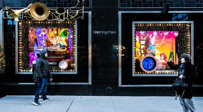 Pedestrians walk past holiday windows display at the Bloomingdale's Inc. store in New York.