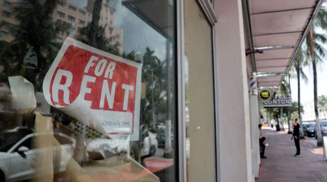 A "For Rent" sign hangs on a closed shop in Miami Beach, Fla., on July 13.