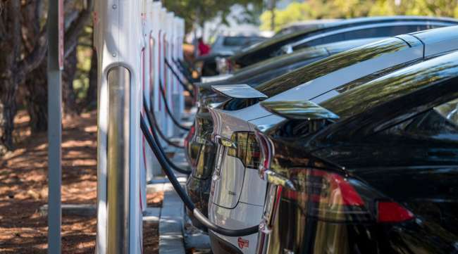 Tesla vehicles charge at a station in San Mateo, Calif., on Sept. 22.