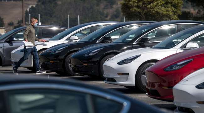 Tesla vehicles sit in a lot at a Tesla store in Colma, Calif., on Sept. 24.
