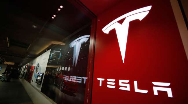 Tesla signs are seen in a Denver mall in February 2019.