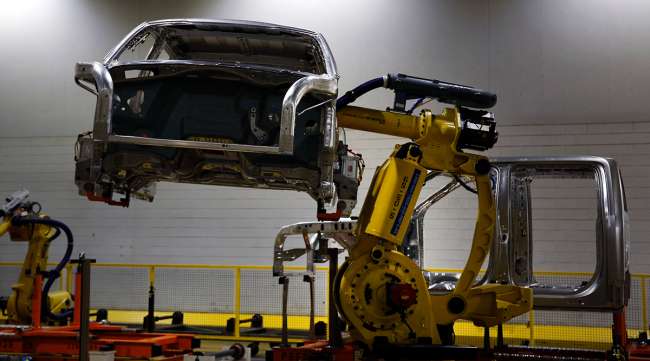 A robot moves a Ford Motor Co. F150 truck on the production line at the company's Dearborn Truck Assembly facility in Dearborn, Mich.