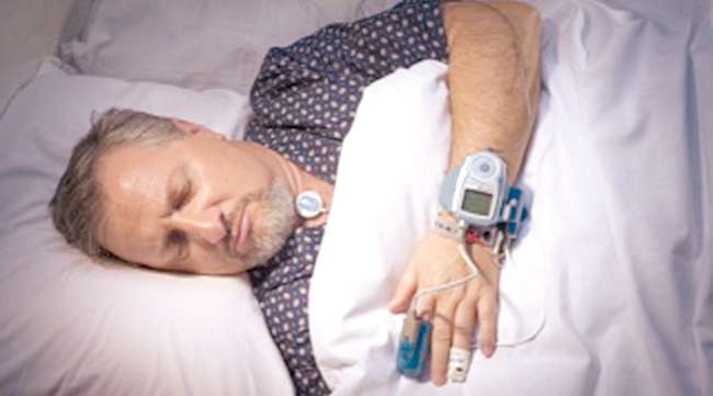 man sleeping during sleep apnea test