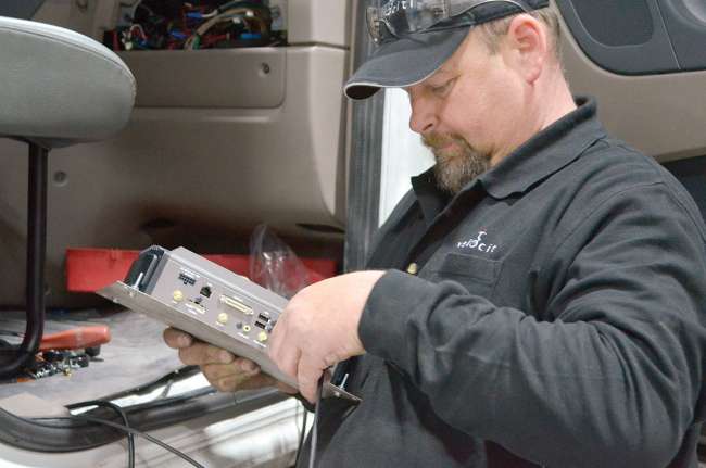 A Velociti technician works on in-cab technology