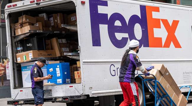A FedEx driver scans packages in San Francisco