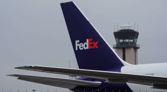 A FedEx cargo plane sits parked at San Diego International Airport on April 27.