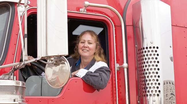 Woman behind the wheel of truck cab