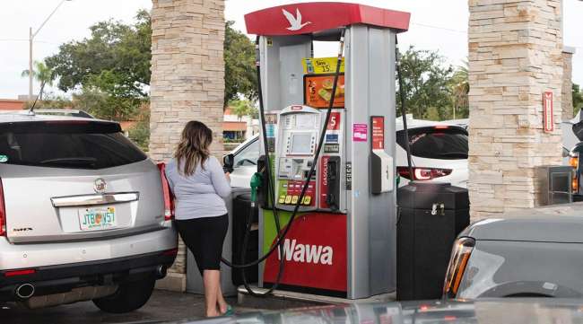 Customers refuel at a gas station ahead of Hurricane Ian in St. Petersburg, Fla.