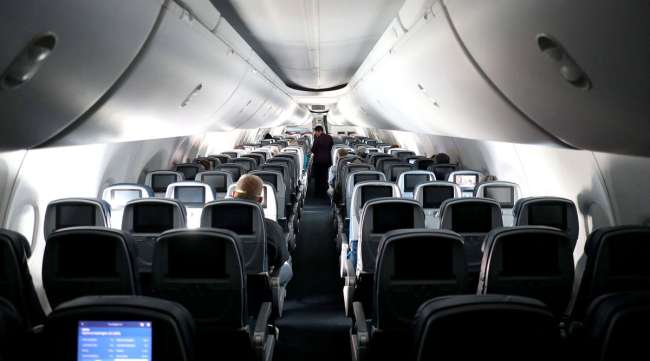 A flight attendant checks on passengers on a Delta flight April 20.